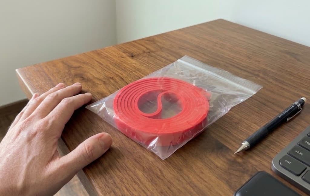 Ruck & Run resistance band in packaging on a home desk